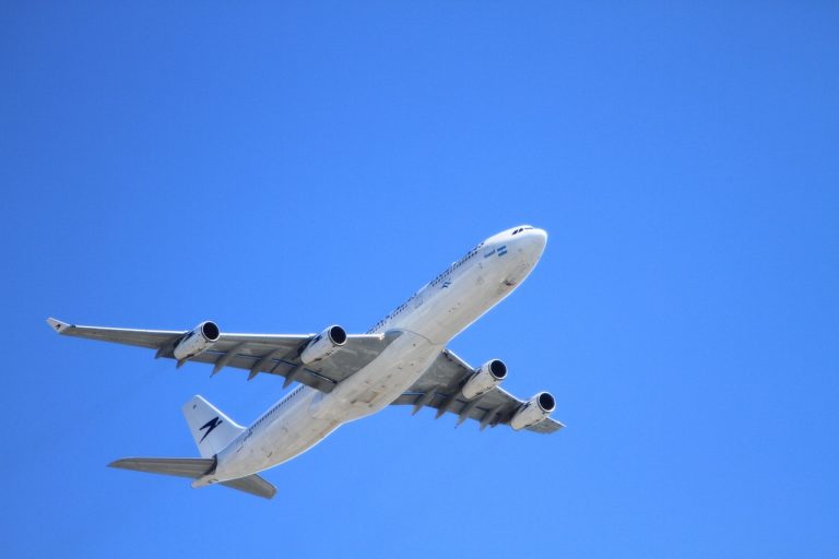 plane flying in blue sky